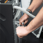 Tullys German Appliance Engineer repairing a Miele Appliance